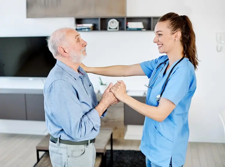 in home caregiver assisting senior man with help