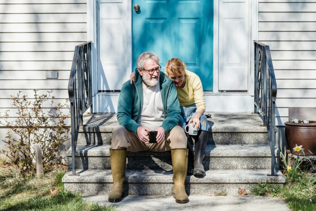 An elderly couple at home enjoying coffee together.