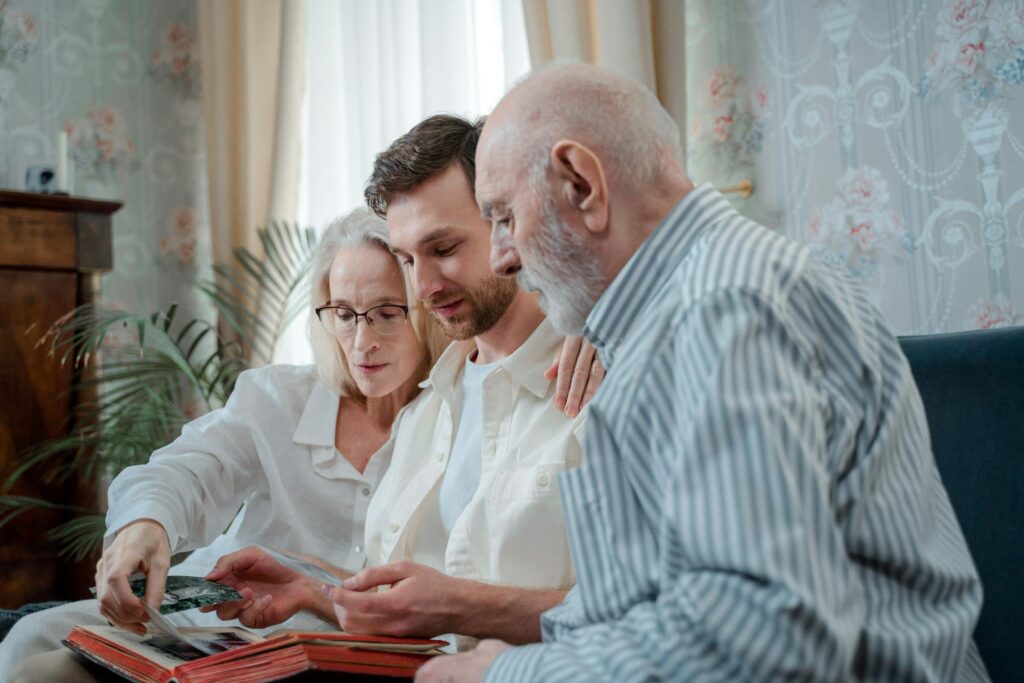 A family browsing a photo album together at home.